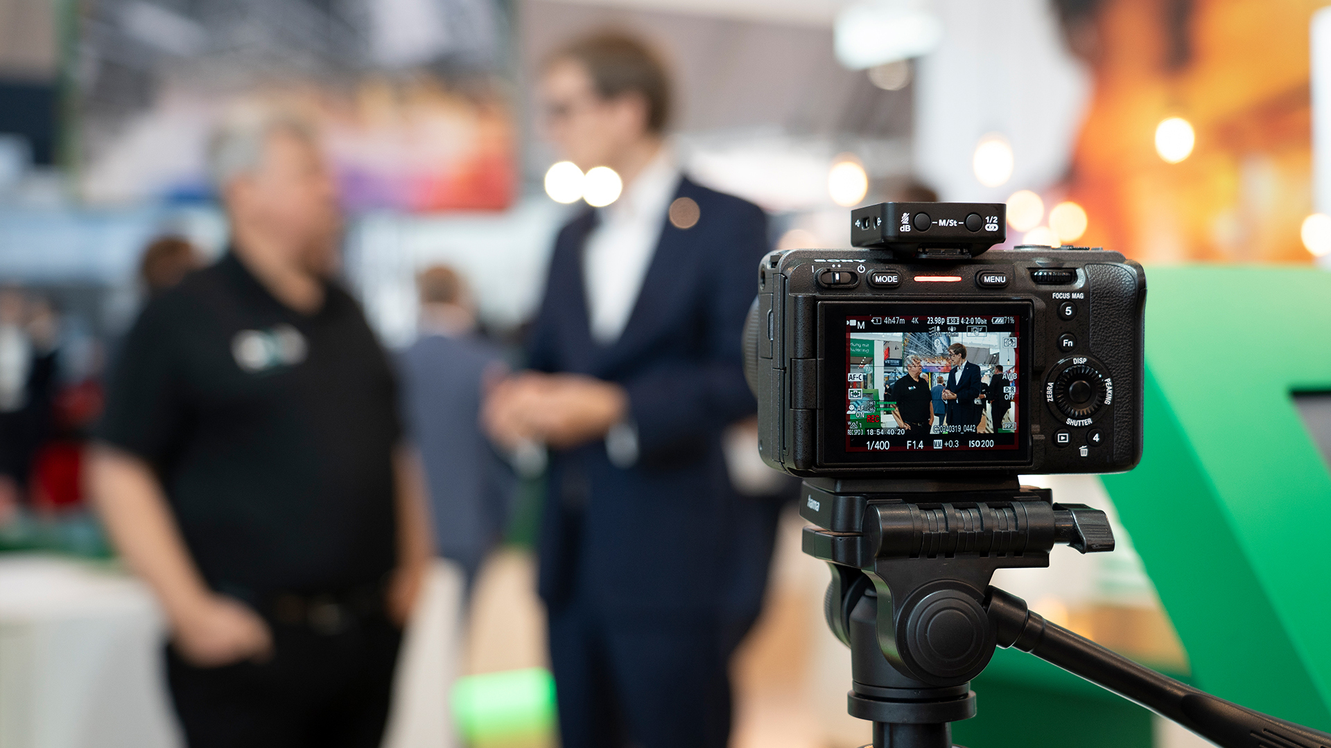 Camera takes pictures at a trade show